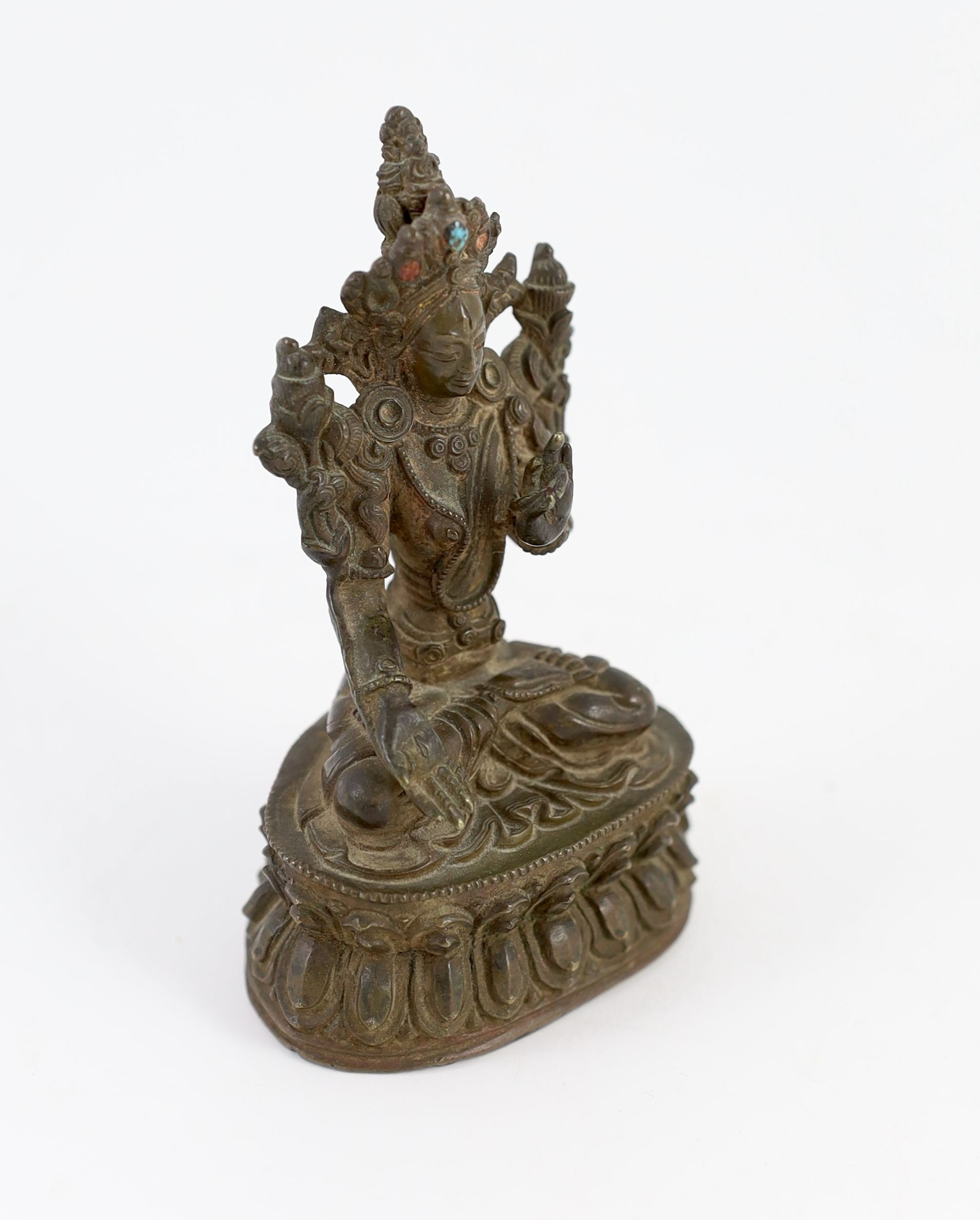 A Tibetan bronze seated figure of White Tara, 17th/18th century, 11 cm high